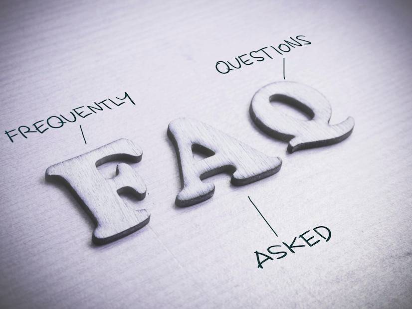 Textured wooden letters spelling FAQ with Frequently above and Asked Questions below, set against a light background.